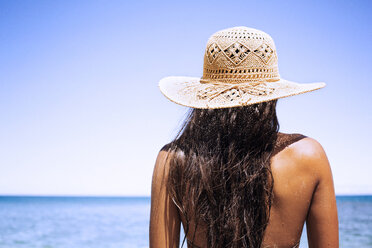 Rear view of woman wearing sun hat standing against clear sky - CAVF01452
