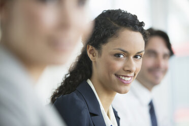 Businesswoman smiling in meeting - CAIF08035