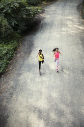 High angle view of women jogging on road - CAVF01602