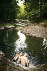 High angle view of friends sitting at lakeshore - CAVF01664