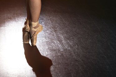Low section of ballet dancer standing at studio - CAVF01962