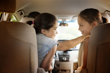 Rear view of girls traveling in car - CAVF02235