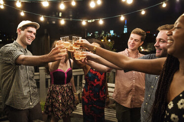 Cheerful friends toasting drinks at party - CAVF02262