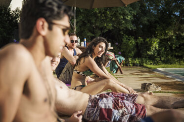 Happy friends relaxing at poolside - CAVF02303