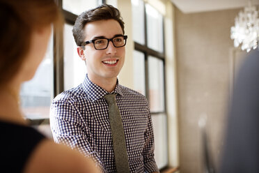 Man looking at friends at home - CAVF02495