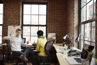 Businesswoman sitting in office - CAVF02611