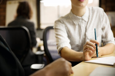 Midsection of businesswoman with colleague in office - CAVF02621