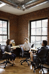 Businesswomen discussing in office - CAVF02624