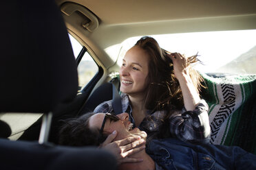 Cheerful couple traveling in car - CAVF02748