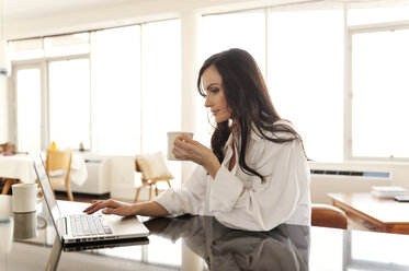 Close-up of woman using laptop on table - CAVF02863