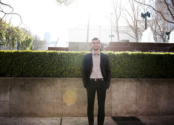 Portrait of smiling young businessman on sunny day - CAVF02922