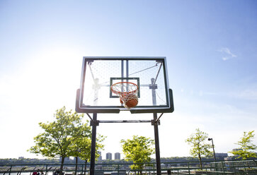 Half basketball courts with view of majestic mountain and overcast gray sky  Stock Photo