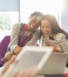 University students laughing in lounge - CAIF08194