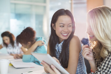 University students using digital tablet in classroom - CAIF08219