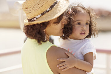 Close-up of mother carrying daughter - CAVF03339