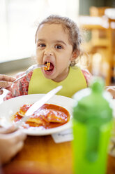 Portrait of girl eating food at restaurant - CAVF03352