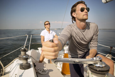 Friends looking up while sailing in yacht - CAVF03911