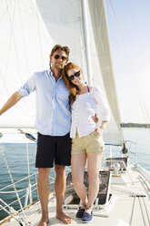 Portrait of happy couple standing at yacht - CAVF03917