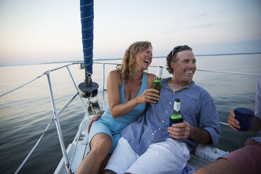 Couple enjoying drink while traveling in yacht - CAVF03952