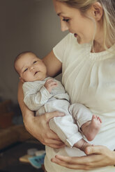 Newborn baby being held in mother’s arms - MFF04388