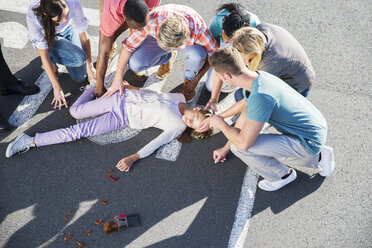 People rushing to injured girl on street - CAIF08520