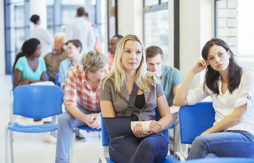 Women sitting in hospital waiting room - CAIF08530