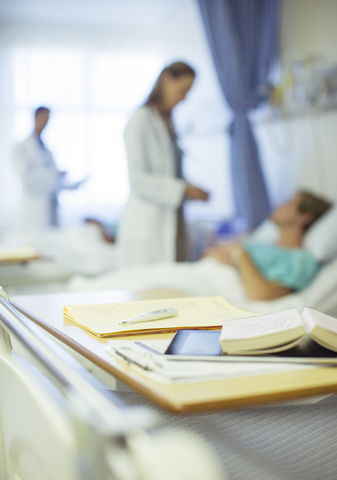 Nahaufnahme von Büchern auf einem Bettkasten im Krankenhaus, lizenzfreies Stockfoto