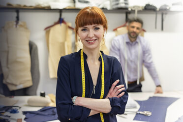 Portrait confident female tailor in menswear workshop - CAIF08560