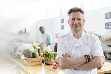 Portrait smiling chef in commercial kitchen - CAIF08742