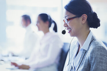 Smiling businesswoman talking on the phone with headset - CAIF09000