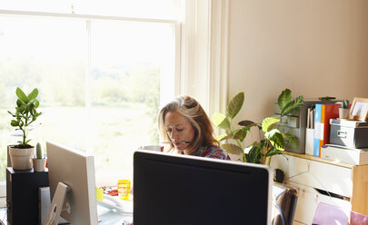 Konzentrierte Frau arbeitet im Home Office - CAIF09020