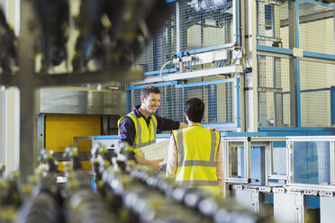 Workers talking in factory - CAIF09040