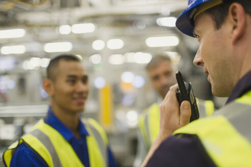 Worker using walkie-talkie in factory - CAIF09048