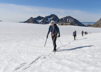 Greenland, Sermersooq, Kulusuk, Schweizerland Alps, group of people walking in snow - ALRF00929