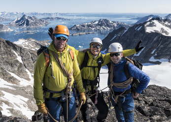 Greenland, Sermersooq, Kulusuk, Schweizerland Alps, portrait of happy mountaineers on summit - ALRF00931
