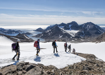 Greenland, Sermersooq, Kulusuk, Schweizerland Alps, group of people walking in snow - ALRF00934