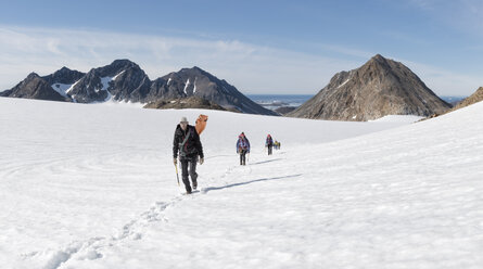 Greenland, Sermersooq, Kulusuk, Schweizerland Alps, group of people walking in snow - ALRF00936
