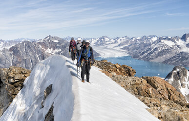 Greenland, Sermersooq, Kulusuk, Schweizerland Alps, mountaineers walking in snowy mountainscape - ALRF00951