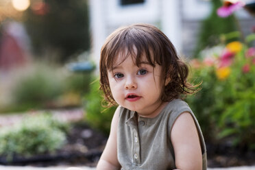 Portrait of cute girl sitting at backyard - CAVF04159