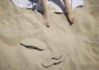 Low section of woman on sand - CAVF04256