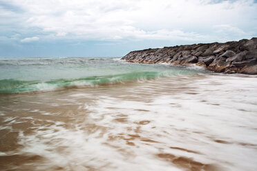 Scenic view of beach against cloudy sky - CAVF04316