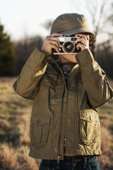 Junge fotografiert auf einem Feld stehend - CAVF04332