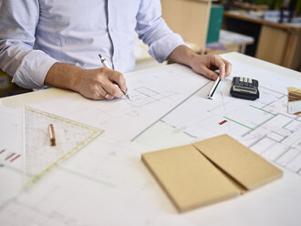 Architect working on construction drawing - CVF00284