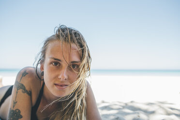 Cuba, Varadero Beach, Young woman with tattoo on the beach - GUSF00529