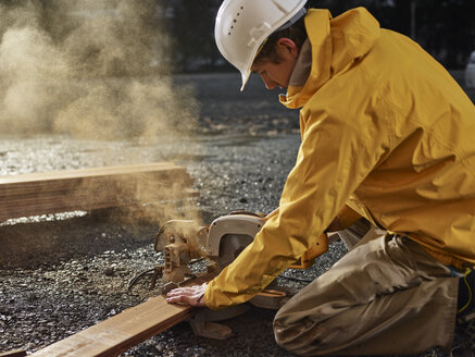 Man sawing decking board with circular saw - CVF00295