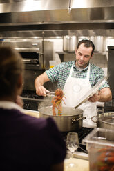 Man preparing lobster at commercial kitchen - CAVF04514