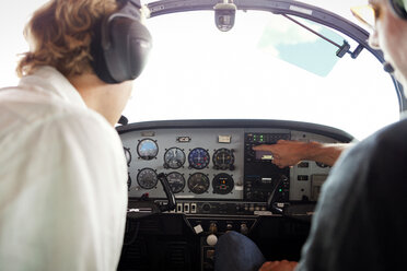 Mechanics examining cockpit of airplane - CAVF04551