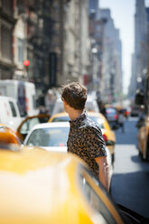 Side view of man standing by cars on road - CAVF04595