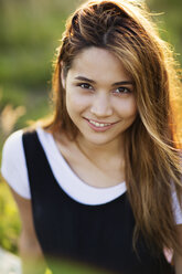 Portrait of smiling woman in field - CAVF04642