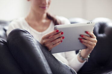 Cropped image of woman using tablet computer at home - CAVF04668